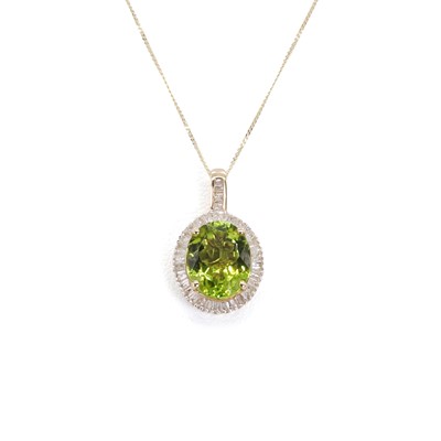 Lot 1185 - A peridot and diamond pendant