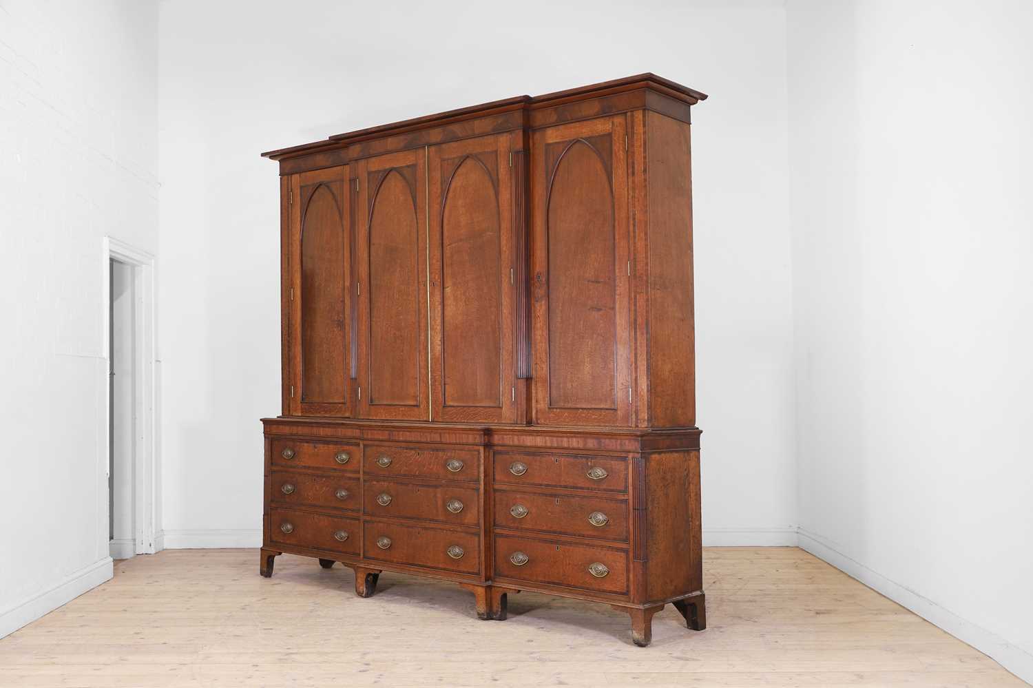 Lot 49 - A George III oak housekeeper’s cabinet