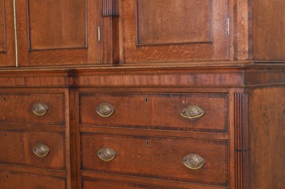 Lot 49 - A George III oak housekeeper’s cabinet