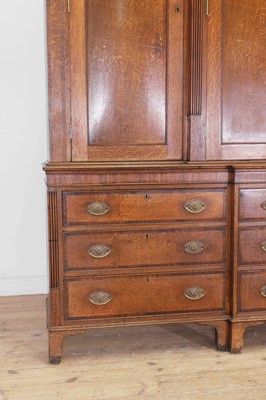 Lot 49 - A George III oak housekeeper’s cabinet