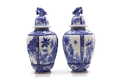 Lot 258 - A pair of Delft vases and covers