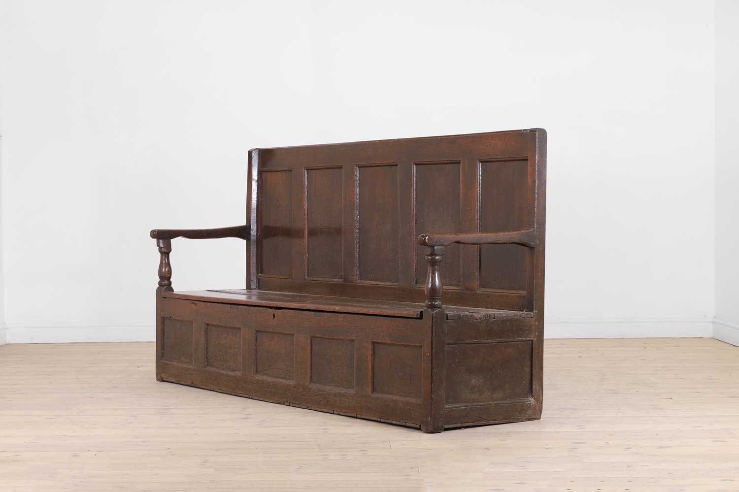 Lot 58 - A panelled oak settle