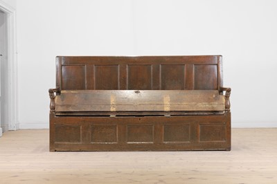 Lot 58 - A panelled oak settle