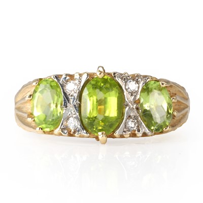 Lot 122 - A peridot and diamond three stone ring