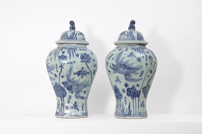 Lot 60 - A pair of blue and white porcelain vases and covers