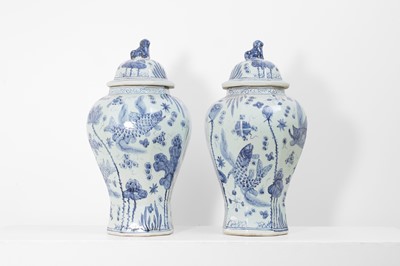 Lot 60 - A pair of blue and white porcelain vases and covers