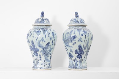 Lot 60 - A pair of blue and white porcelain vases and covers