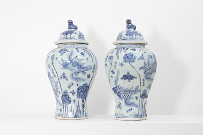 Lot 60 - A pair of blue and white porcelain vases and covers