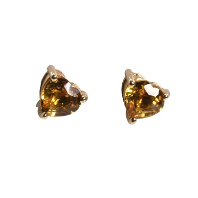 Lot 1187 - A pair of yellow sapphire stud earrings