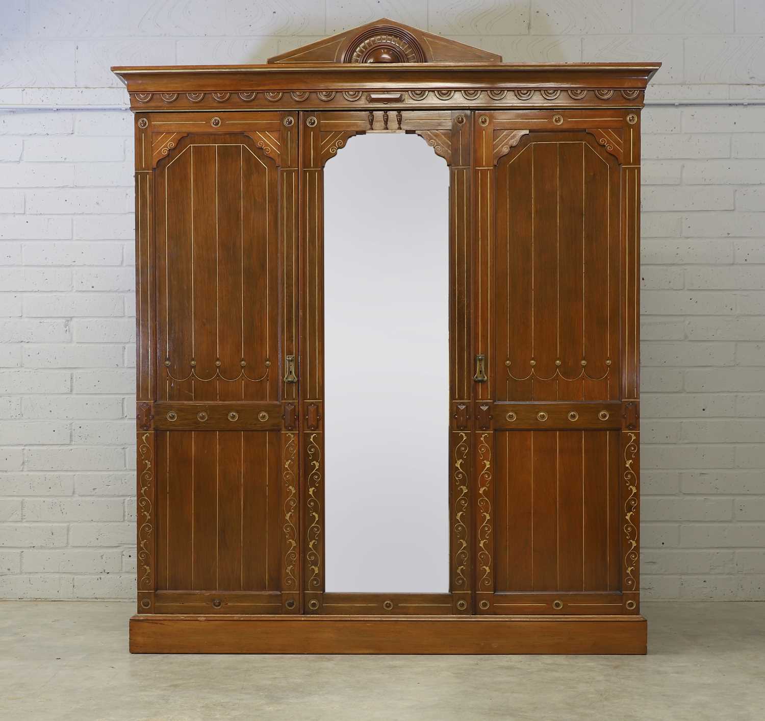 Lot 5 - An Heal & Co. Aesthetic walnut and gilt wardrobe