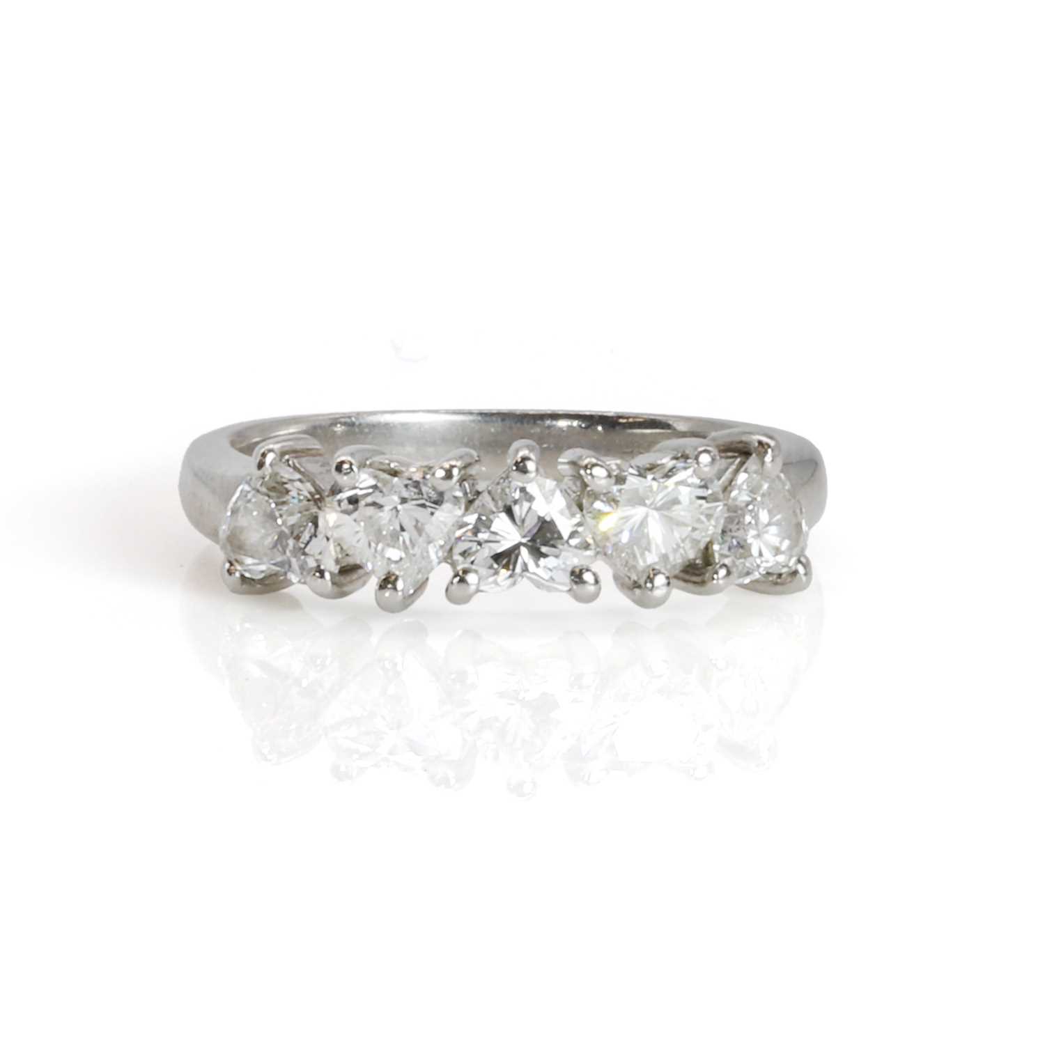 Lot 108 - A platinum and heart shaped diamond five stone ring