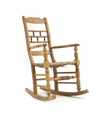 Lot 642 - An ask spindle back rocking chair