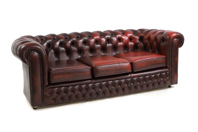 Lot 581 - A red leather Chesterfield sofa