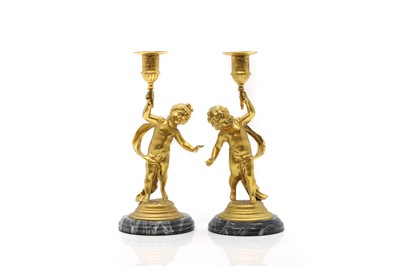 Lot 303A - A pair of gilt metal candlesticks