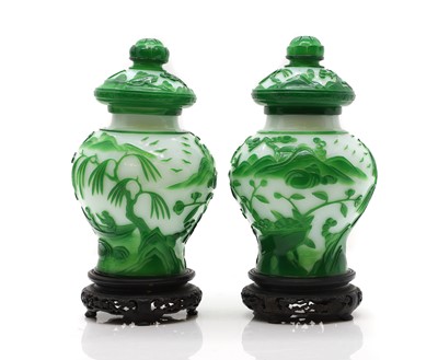 Lot 43 - A pair of Chinese overlay Peking glass vases and covers