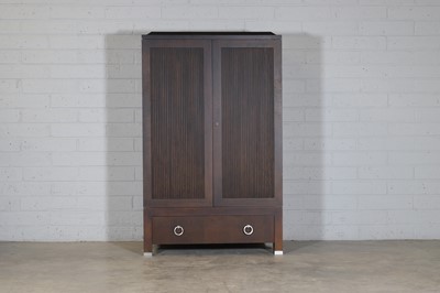 Lot 470 - A dark wood cabinet with two reeded panel doors