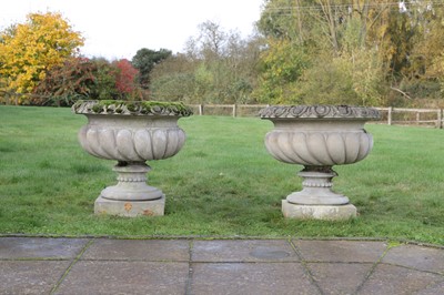 Lot 641 - A pair of composition stone urns