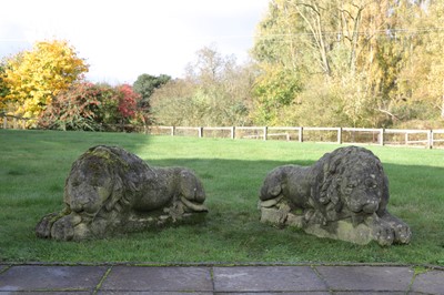 Lot 633 - A pair of composition stone lions