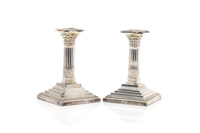 Lot 2 - A pair of silver Corinthian column candlesticks