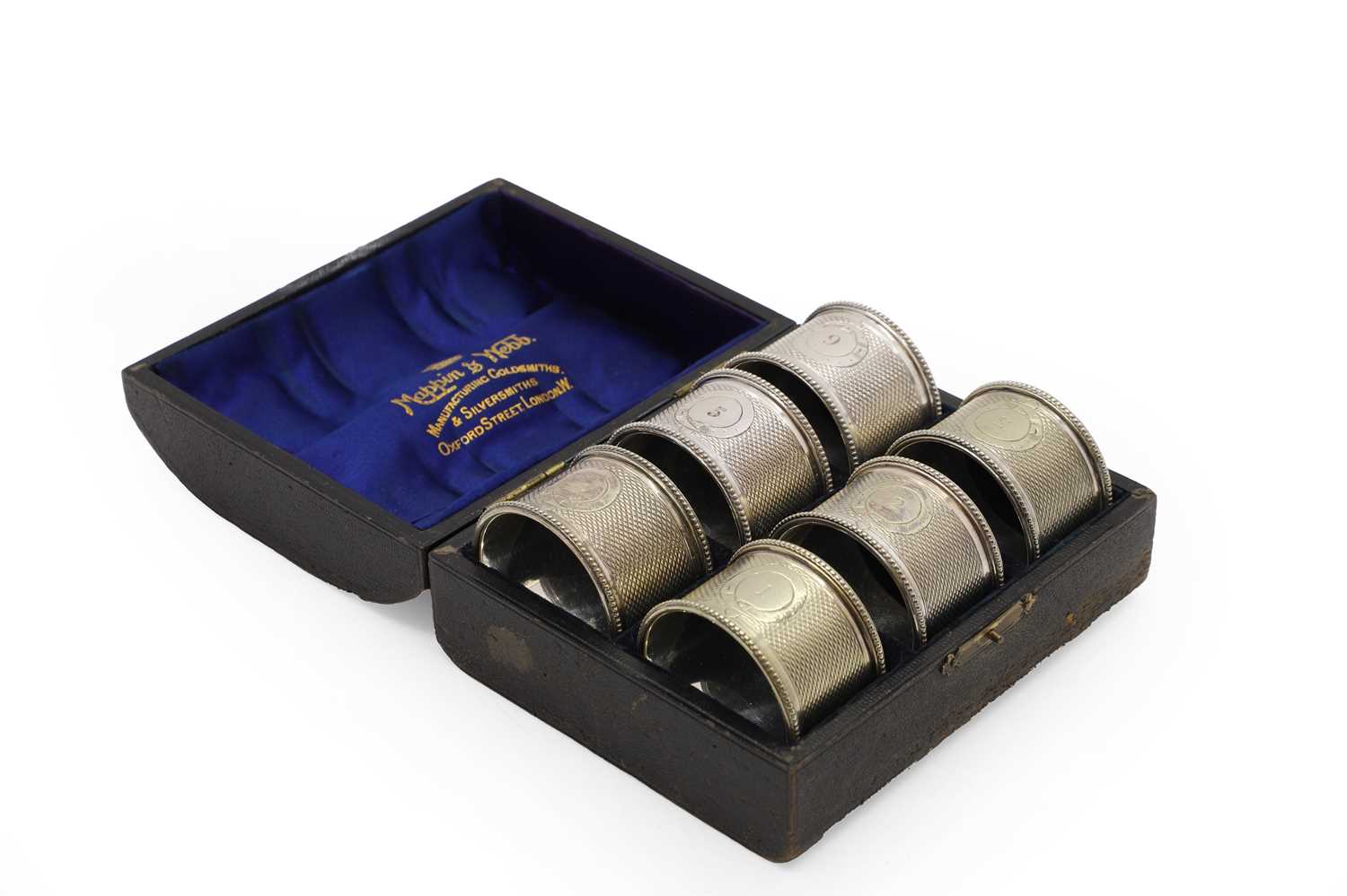 Lot 23 - A cased set of six silver napkin rings,