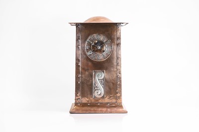 Lot 49 - An Arts and Crafts embossed copper and silvered mantel clock