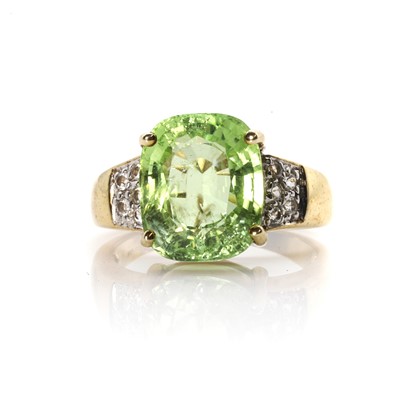 Lot 120 - A 9ct gold peridot and cubic zirconia cluster ring