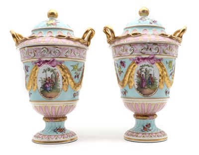 Lot 327 - A pair of Dresden porcelain urns and covers