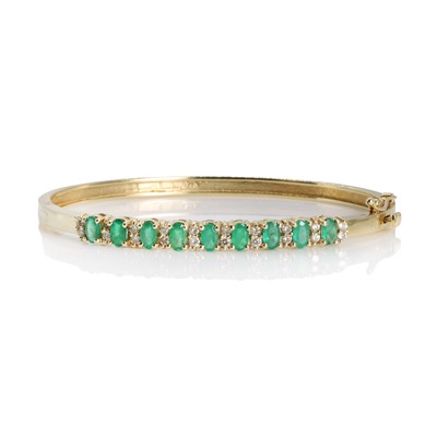 Lot 244 - An emerald and diamond hinged bangle