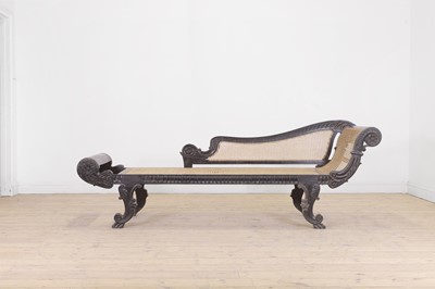 Lot 166 - An ebony and cane chaise longue