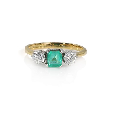 Lot 241 - An 18ct gold emerald and diamond three stone ring