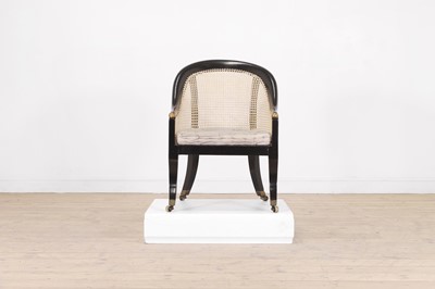 Lot 165 - A Regency ebonised wooden bergère library armchair attributed to Gillows