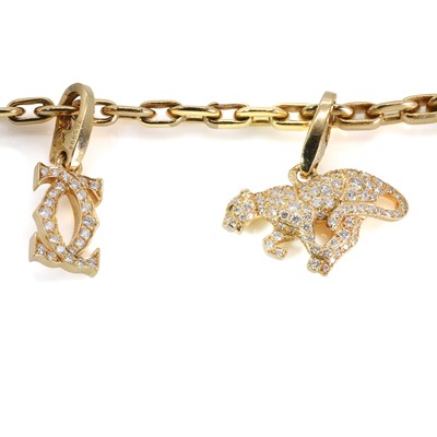 Lot 170 - An 18ct gold diamond charm bracelet, by Cartier