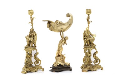 Lot 275 - A pair of figural gilt bronze candlesticks