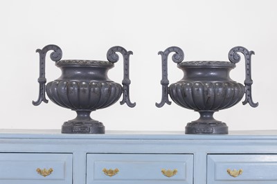 Lot 605 - A pair of cast iron garden urns