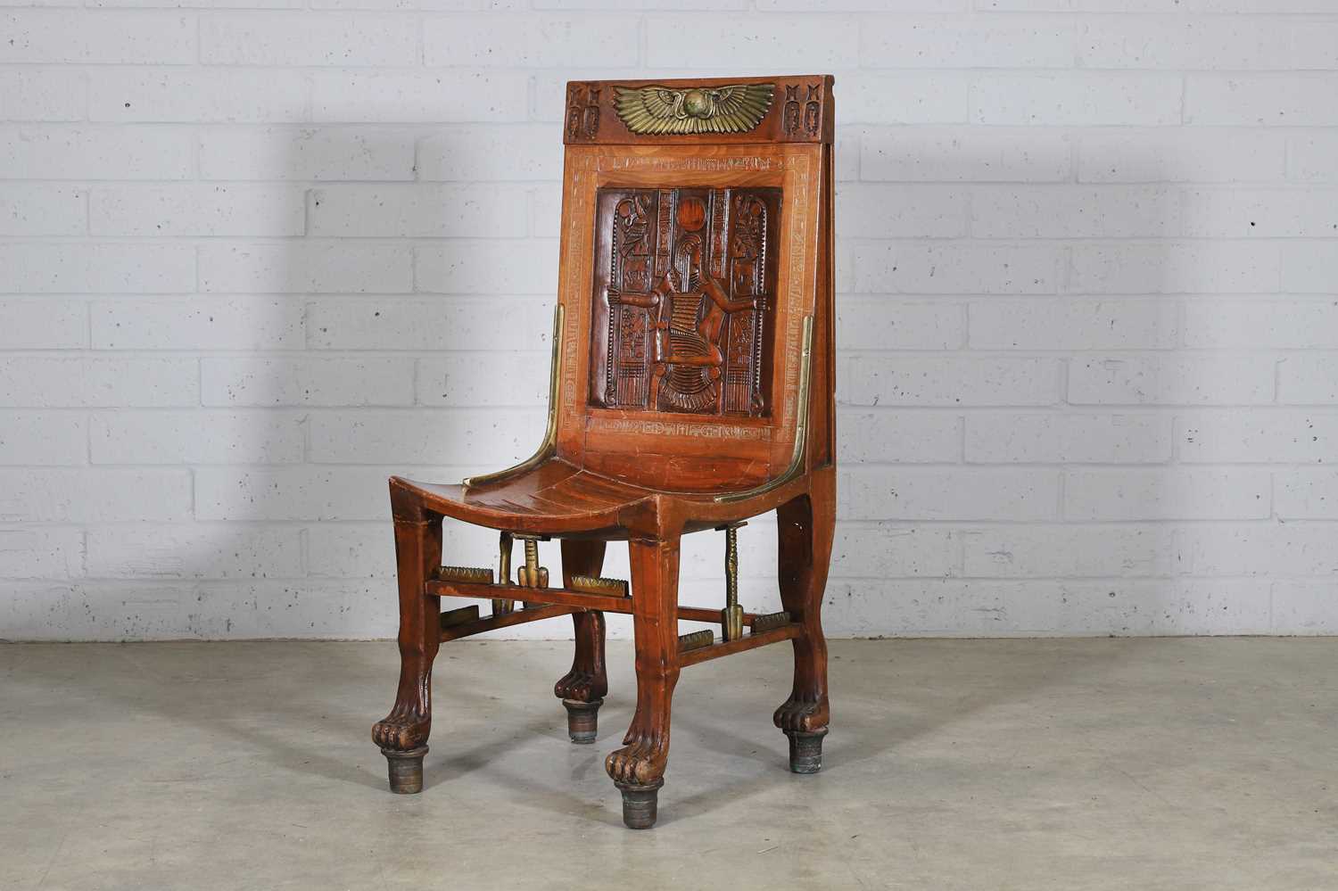 Lot 114 - An 'Egyptomania' brass-mounted stained beech chair