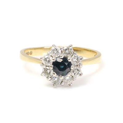 Lot 1153 - An 18ct gold sapphire and diamond cluster ring