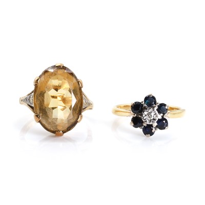 Lot 1292 - An 18ct gold sapphire and diamond cluster ring and a citrine ring