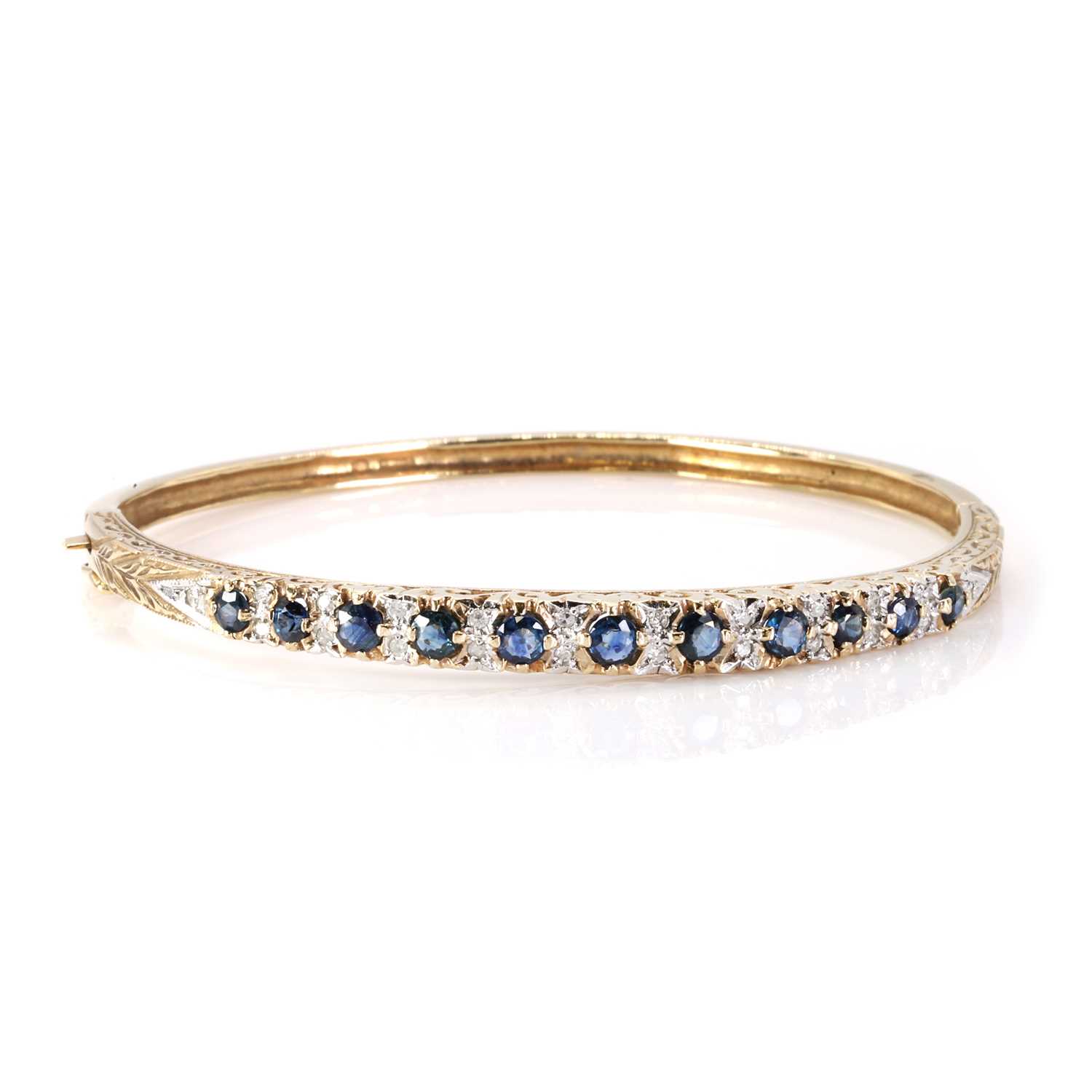 Lot 1149 - A 9ct gold sapphire and diamond hinged bangle