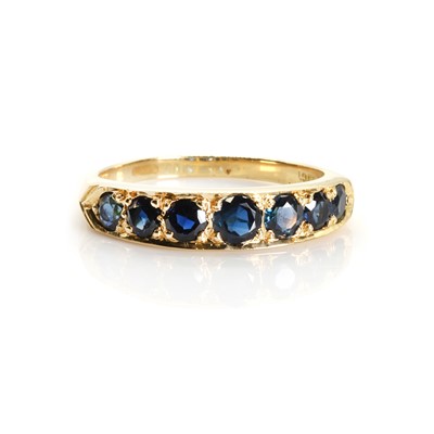 Lot 1150 - A graduated seven stone sapphire half eternity ring