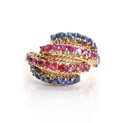 Lot 85 - A four row sapphire and ruby bombe ring, c.1950