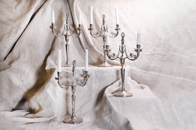 Lot 413 - A set of four Italian silver two-branch candelabra