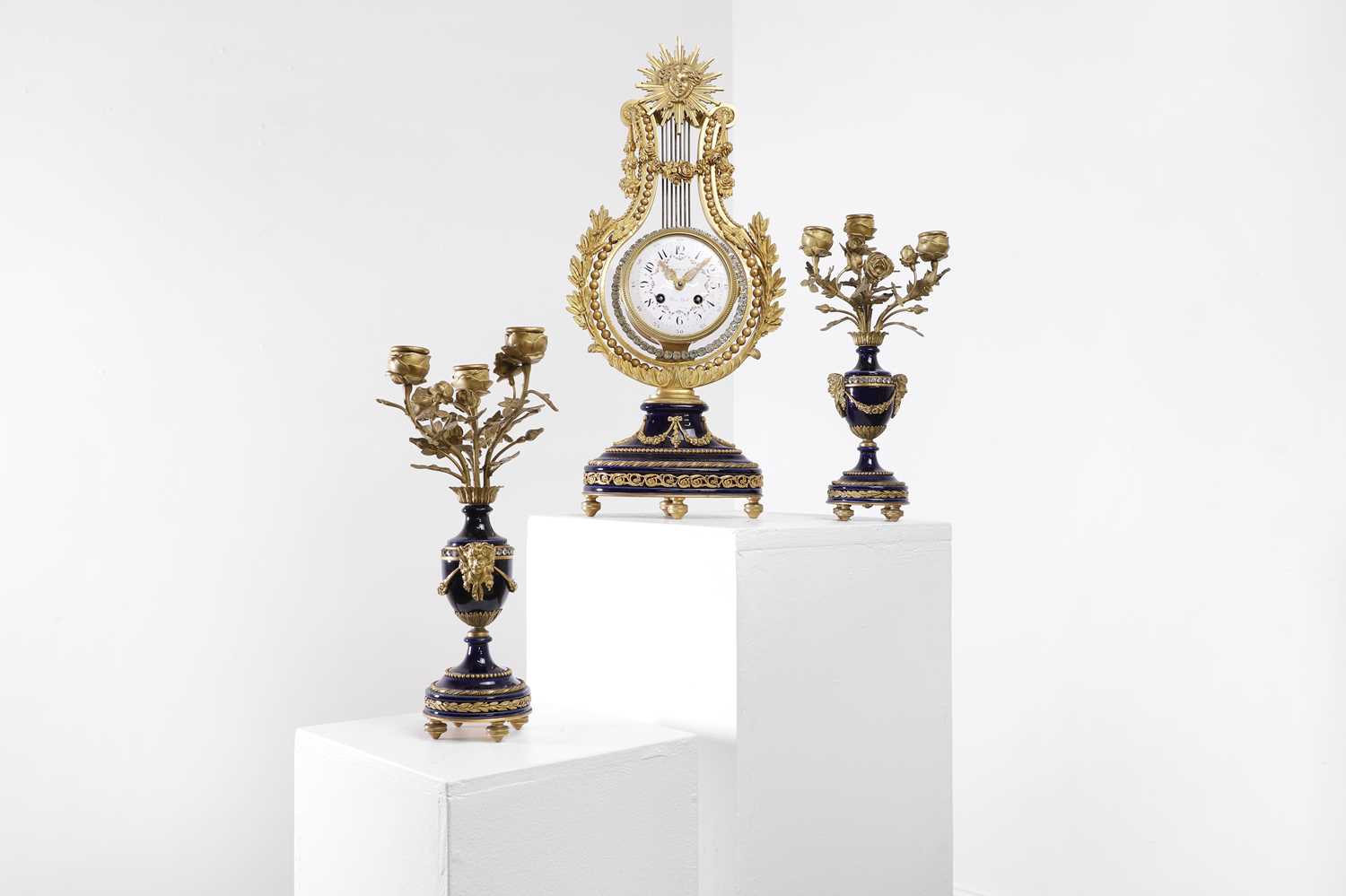 Lot 106 - A Louis XVI-style porcelain and gilt-metal clock garniture