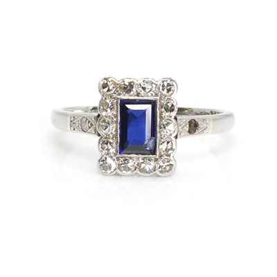 Lot 1066 - A synthetic sapphire and diamond cluster ring