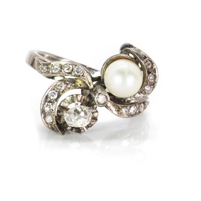 Lot 80 - A pearl and diamond crossover design ring