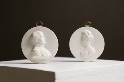 Lot 399 - A pair of biscuit porcelain medallions