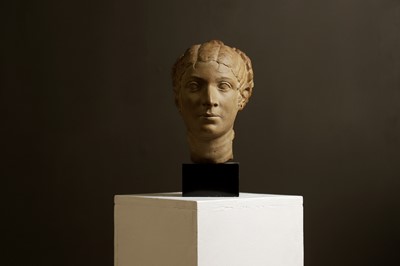 Lot 381 - An imitation limestone head of a Roman woman