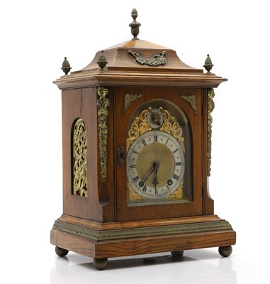 Lot 447 - A German oak ting-tang mantel clock