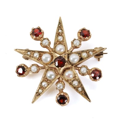 Lot 1209 - A 9ct gold garnet and split pearl starburst brooch