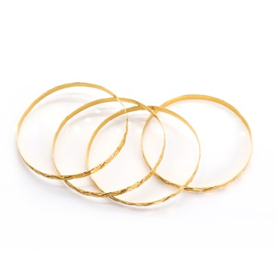 Lot 1350 - A group of four gold bangles