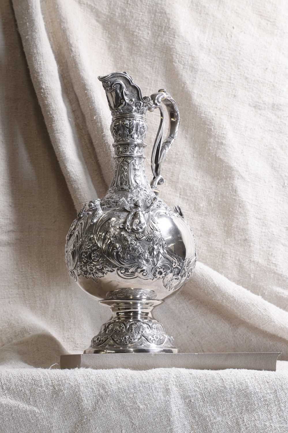 Lot 409 - A Victorian silver Armada pattern claret jug